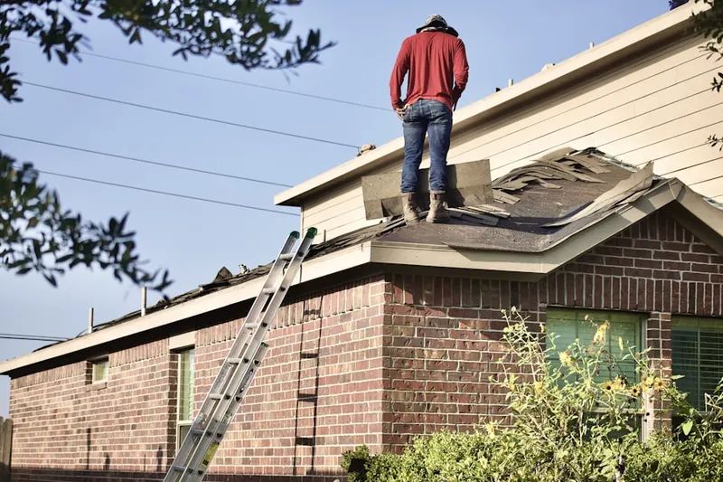 Professional roofer working on a residential roof in La Sierra Acres